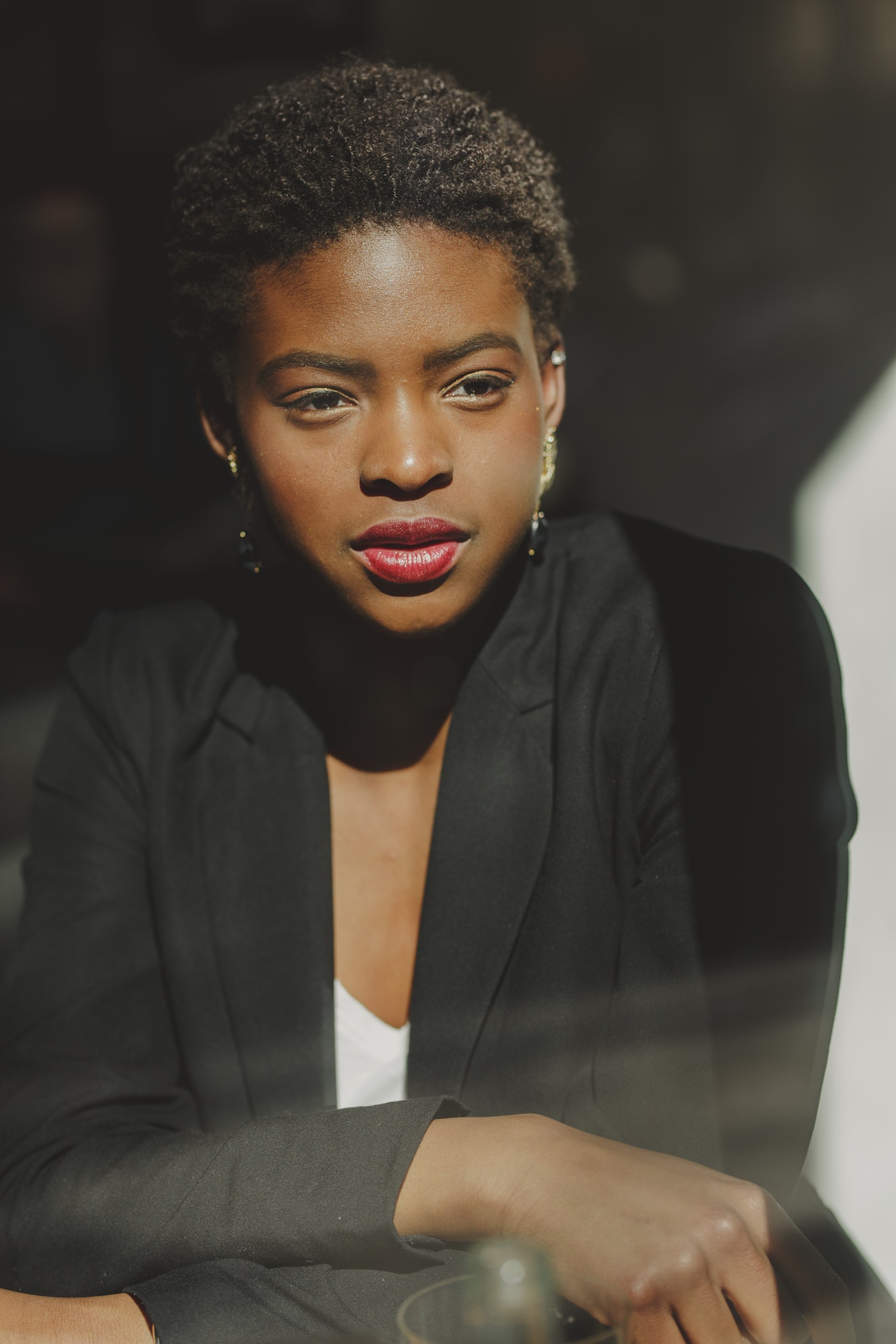 Smiling stylish black woman in cafe